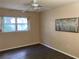 Serene bedroom with a ceiling fan, natural light, and modern vinyl flooring at 6032 Arlene Way, Bradenton, FL 34207