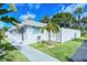 Exterior view of a community building with an office, a palm tree, and green grass at 6032 Arlene Way, Bradenton, FL 34207