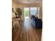 Bright condo living room with dining area and access to lanai at 6032 Arlene Way, Bradenton, FL 34207