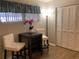 Comfortable living room featuring a window with blinds, a decorative lamp, and closet with bi-fold doors at 6032 Arlene Way, Bradenton, FL 34207