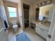 Modest bathroom with walk-in shower, blue accents, and a large mirror at 604 Dundee Ln, Holmes Beach, FL 34217