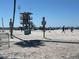 Lifeguard tower on a beach with tourists under clear blue skies at 604 Dundee Ln, Holmes Beach, FL 34217