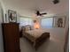 Cozy bedroom features a ceiling fan, two windows, and hardwood furniture accents at 604 Dundee Ln, Holmes Beach, FL 34217