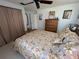 Comfortable bedroom showcases a ceiling fan, closet and wooden dresser with mirror at 604 Dundee Ln, Holmes Beach, FL 34217