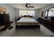 Cozy bedroom with a wooden bed frame, unique quilt, and matching dark wood dressers for ample storage at 604 Dundee Ln, Holmes Beach, FL 34217
