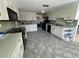 Spacious kitchen with white cabinetry, ample counter space, and modern appliances, perfect for culinary enthusiasts at 604 Dundee Ln, Holmes Beach, FL 34217