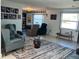 Inviting living room featuring comfortable seating, a decorative rug, and ample natural light from large windows at 604 Dundee Ln, Holmes Beach, FL 34217