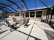 Covered patio with a round table, seating, and a view of the pool at 604 Dundee Ln, Holmes Beach, FL 34217