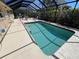 Relaxing pool area with screened enclosure and outdoor furniture at 604 Dundee Ln, Holmes Beach, FL 34217