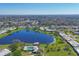 Scenic aerial view of the neighborhood pond surrounded by lush landscaping and residential buildings at 6418 13Th Avenue W Dr, Bradenton, FL 34209