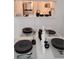 Dining room featuring table set for four with sleek, dark dishware and minimalist decor at 6924 Stones Throw N Cir # 8105, St Petersburg, FL 33710