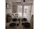 Bright dining room featuring tile floors, stylish furniture, and sliding glass doors to the outside at 6924 Stones Throw N Cir # 8105, St Petersburg, FL 33710