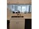 Kitchen view overlooking the living room, featuring modern white countertops and black appliances at 6924 Stones Throw N Cir # 8105, St Petersburg, FL 33710