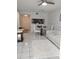 Open-concept living and dining area with modern furniture and a pass-through to the kitchen at 6924 Stones Throw N Cir # 8105, St Petersburg, FL 33710