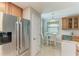 Kitchen and dining area featuring a stainless steel refrigerator and a window view at 7004 Grand Estuary Trl # 101, Bradenton, FL 34212