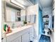 Well-lit bathroom featuring a large mirror, modern sink, and white marble tile at 7067 Jarvis Rd, Sarasota, FL 34241