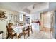 Sunlit kitchen with white cabinets, stainless steel appliances, and a cozy breakfast nook at 7067 Jarvis Rd, Sarasota, FL 34241