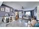 Comfortable living room featuring grey tile floors, a staircase, and a bright window at 7067 Jarvis Rd, Sarasota, FL 34241