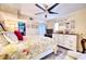 Comfortable main bedroom with a decorative ceiling fan, large window, and walk-in closet at 7067 Jarvis Rd, Sarasota, FL 34241