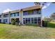 Exterior view of a multi-story condo featuring an enclosed sunroom at 7193 W Country Club N Dr # 140, Sarasota, FL 34243