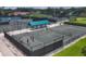 Aerial shot of outdoor tennis courts with players and viewing areas at 7193 W Country Club N Dr # 140, Sarasota, FL 34243