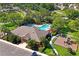 Aerial view showcasing the community pool, clubhouse, playground, and lush landscaping at 7326 Skybird Rd, Bradenton, FL 34209