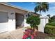 Charming front entrance of this home with ornamental door, flowers, and meticulous landscaping at 7402 9Th Ave W # 7402, Bradenton, FL 34209