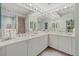 Bright bathroom featuring double sinks with a spacious vanity and ample lighting at 7416 Botanica Pkwy # 103, Sarasota, FL 34238