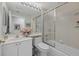 Clean and functional bathroom offers a shower-tub combo, lots of light and vanity storage at 7416 Botanica Pkwy # 103, Sarasota, FL 34238