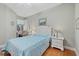 Comfortable bedroom offers hardwood floors, a large window, and a built-in desk at 7416 Botanica Pkwy # 103, Sarasota, FL 34238