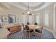 Elegant room with table seating, shuttered windows, and stylish decor in the clubhouse at 7416 Botanica Pkwy # 103, Sarasota, FL 34238