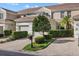 Beautiful exterior of townhome featuring a brick driveway, manicured landscaping, and neutral color palette at 7416 Botanica Pkwy # 103, Sarasota, FL 34238
