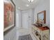 Bright foyer with tile flooring, a decorative console table and striking paintings at 7416 Botanica Pkwy # 103, Sarasota, FL 34238