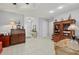 Light and bright foyer with neutral tile flooring and decorative furnishings at 7416 Botanica Pkwy # 103, Sarasota, FL 34238