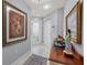 Neutral hallway featuring artwork, console table and a view of the front door at 7416 Botanica Pkwy # 103, Sarasota, FL 34238