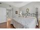 Serene main bedroom with a decorative wrought iron bed frame and wood flooring at 7416 Botanica Pkwy # 103, Sarasota, FL 34238