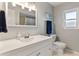 Bathroom with white vanity, bright lighting, and a view into a tub-shower combo at 7520 Curtiss Ave, Sarasota, FL 34231