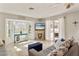 Cozy living room with bay windows, a decorative fireplace, and sliding glass doors to the patio at 7520 Curtiss Ave, Sarasota, FL 34231