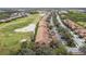 Aerial view showcasing the neighborhood's layout with homes lining the golf course and a nearby pond at 803 Fairwaycove Ln # 106, Bradenton, FL 34212