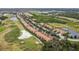 Aerial view showing homes and green golf course areas and ponds at 803 Fairwaycove Ln # 106, Bradenton, FL 34212