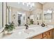 Stylish bathroom with wooden vanity, quartz countertop, and a view into the connected bedroom at 803 Fairwaycove Ln # 106, Bradenton, FL 34212