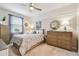 Serene bedroom with a comfortable bed, elegant dresser, stylish mirror, and soft natural light at 803 Fairwaycove Ln # 106, Bradenton, FL 34212