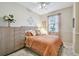 Bright bedroom featuring a comfortable bed with a light orange comforter and decorative pillows at 803 Fairwaycove Ln # 106, Bradenton, FL 34212