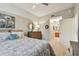 Serene bedroom with ceiling fan, leading to an en-suite bathroom; features patterned bedding and wall art at 803 Fairwaycove Ln # 106, Bradenton, FL 34212