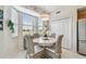 Bright breakfast nook featuring a round table, wicker chairs, and scenic views from the surrounding windows at 803 Fairwaycove Ln # 106, Bradenton, FL 34212