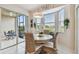 Bright breakfast nook with round table, wicker chairs, and sliding glass doors to outdoor seating at 803 Fairwaycove Ln # 106, Bradenton, FL 34212