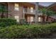 Two-story condo building with lush green landscaping and a charming facade at 803 Fairwaycove Ln # 106, Bradenton, FL 34212