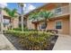 Exterior view of a condo complex surrounded by meticulously maintained landscaping and palm trees at 803 Fairwaycove Ln # 106, Bradenton, FL 34212