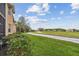 Exterior view of building overlooks community green spaces, providing access to walking paths and outdoor activities at 803 Fairwaycove Ln # 106, Bradenton, FL 34212