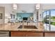 Kitchen island featuring stainless sink and faucet overlooking the living room and the outdoor view at 803 Fairwaycove Ln # 106, Bradenton, FL 34212